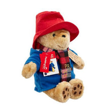 Load image into Gallery viewer, The Large Cuddly Paddington with Scarf has been inspired by the beautiful Peggy Fortnum illustrations.  These artworks are synonymous with the original Paddington books that portray Paddington in his lined duffel coat and his battered old bush hat. This stunning, premium quality, nostalgic Paddington Bear been created specially to commemorate the momentous 60th occasion and features the distinctive anniversary artwork, along with a beautiful checked scarf. 