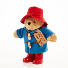 Load image into Gallery viewer, As a standing 25cm plush character, the Classic Paddington with Boots is an iconic addition to any Paddington Bear collection and is the perfect playroom pal to accompany story time for children aged 10 months and over. This striking soft and cuddly character toy features the distinctive and famous Paddington Bear accessories including a super soft lined duffle coat with real toggles, a battered red felt bush hat and &#39;real&#39; shiny red wellington boots